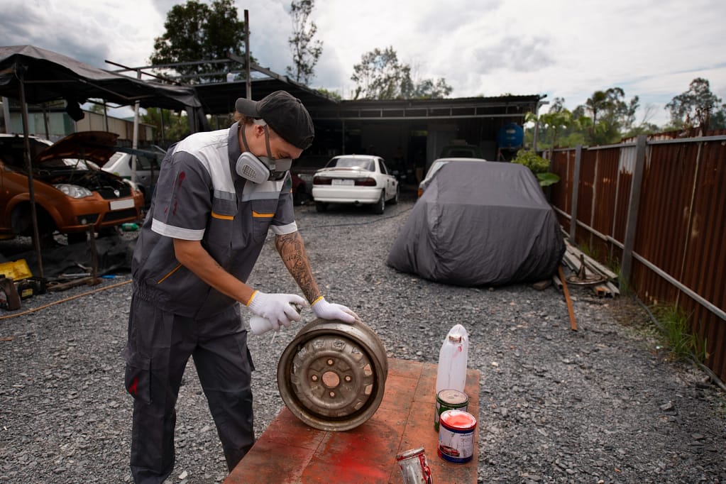 Worker Prepping Junk Car Parts for Recycling - Budget-Friendly Junk Auto Removal