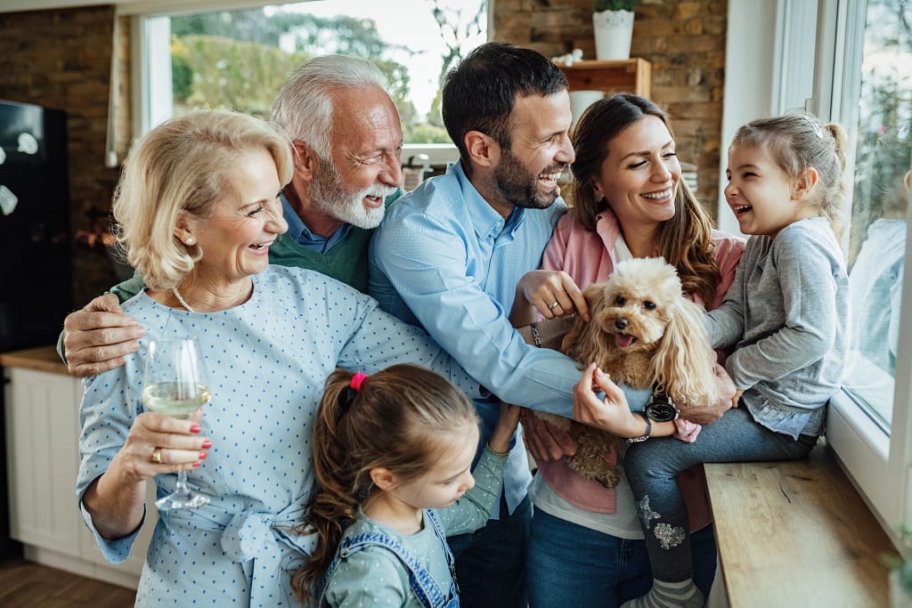 Happy multigenerational family enjoying quality time together with their pet dog.