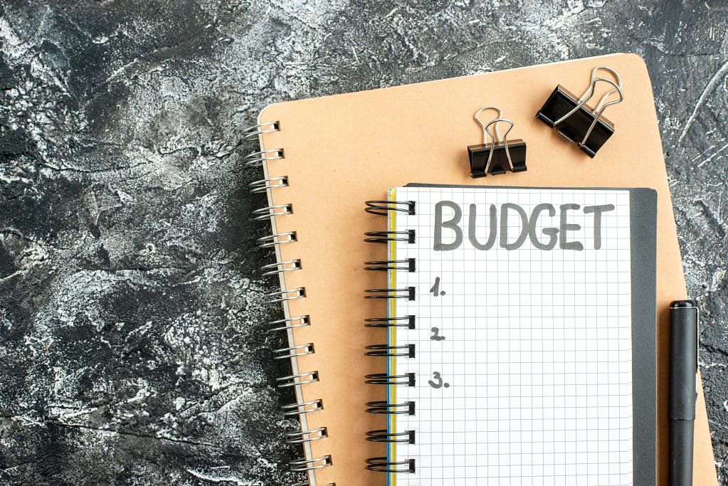Notebook with budgeting tips to maximize scrap car earnings effectively.