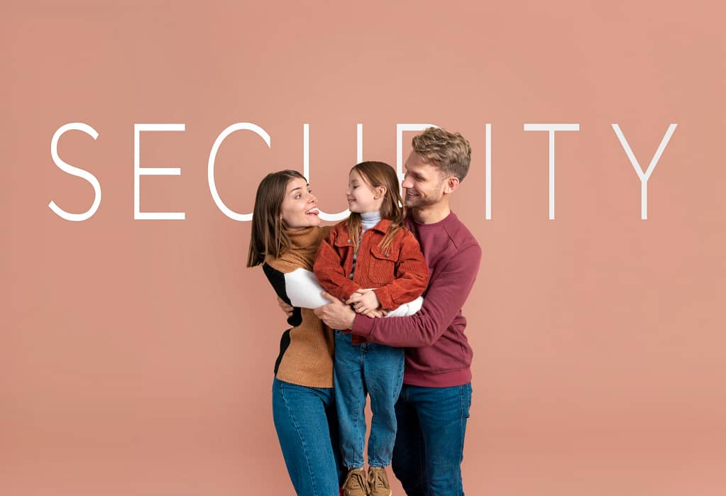 Happy parents holding their child in front of a "SECURITY" backdrop, emphasizing the importance of space, safety, and comfort for families.